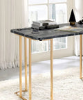 Adjustable Standing Computer Desk With Built Storage And Power Port, Sleek Faux Marble Work Table For Home Office, gold metal frame with books and lamp.