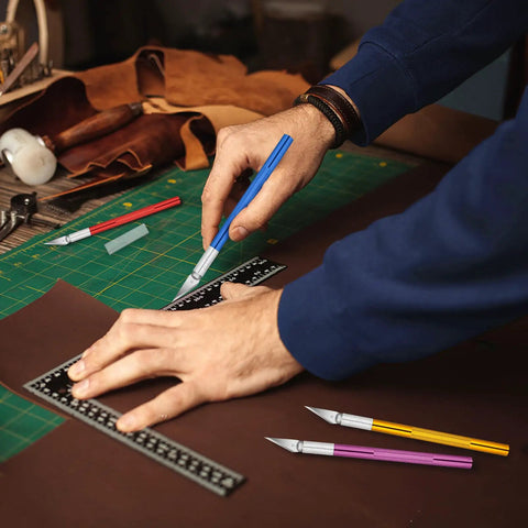 Crafting with 55 Pack Exacto Knife Set With 5 Craft Knives And 50 Precision Blades for Art and DIY, using aluminum handle on cutting mat