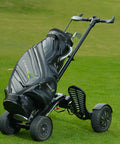 Electric Four Wheel Foldable Golf Cart Trolley With Easy Push Or Ride Options In Classic Black Trim on grass.