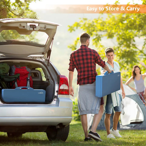 Two people carrying folded 4 Ft Folding Picnic Table Set With 4 Seats And Umbrella Hole Lightweight Aluminum Frame near car trunk