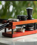 Keep Your Shot Prep Crisp With This Solid Tiered Espresso Tamper Station And Knock Box Organizer Universal 51 To 58 Millimeter Portafilter Holder Natural Wood Coffee Bar Organizer Setup with black tamper and storage.