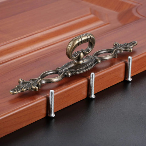 Vintage Style Antique Bronze Cabinet Pulls Handles 2 Pack Hollow Decor with screws on wood surface