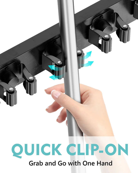 Close-up of No Drill Over The Door Mop And Broom Holder With Four Slots And Four Hooks Wood Tool Hanger in use with hand.
