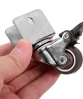 Rugged Swivel Furniture Casters With Gliding Silent Rollers And Tough Round Plates Built For Cabinets Drawers And Office Gear On Hardwood Floors Featuring Quick Fit Brake Clamps For Any Space, held in hand.