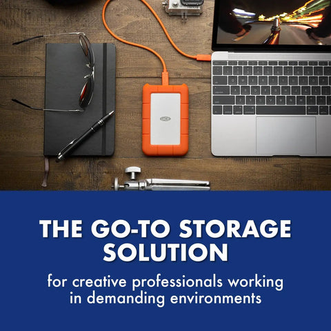 Rugged 5TB Portable External Hard Drive USB Three Point Zero And USB Two Point Zero Compatible next to a laptop on desk