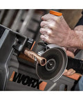 No Hassle Heavy Duty Cordless Angle Grinder With 20 Volt Lithium Ion Battery cutting copper pipe in use with dual grip for control.