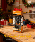 Box of Band Clamp For Woodworking And Picture Framing on a workbench, surrounded by tools and holiday decorations.