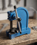Rock Solid Heavy Duty Manual Arbor Press With Cast Iron Frame And Steel Ram For Precision Punching Inserting And Bushing Half To Two Ton Shop Beast Built Tough For Daily Garage Hustle on wooden bench.