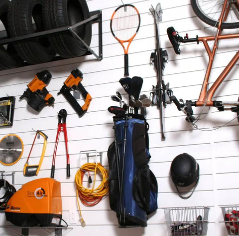 Heavy Duty PVC Slatwall Garage Organizer System 8 Ft By 4 Ft White Panels with assorted tools and sports gear
