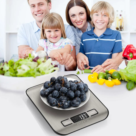 Family in kitchen using Must Have Digital Kitchen Scale With 11 Lb Capacity, 6 Measurement Units in grams and ounces, 304 stainless steel