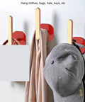 Heavy Duty L Shape Wall Hooks Zero Fuss Install Multipurpose Coat Hanger For Hats Towels Keys Strong Suction in red holding a hat and scarf.