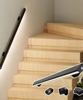 Ultra Smooth Body Sensing Lighted Stair Handrail For Indoor Steps Wall Mounted Safety Rail with sleek black coat, installed on wooden stairs.