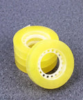 Dope 12 Pack 11mm X 30m BOPP Packing Tape, yellow rolls stacked on gray surface, strong adhesive for packaging and school use