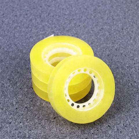 Dope 12 Pack 11mm X 30m BOPP Packing Tape, yellow rolls stacked on gray surface, strong adhesive for packaging and school use