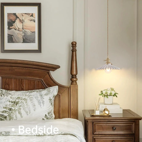 White Pleated Ceramic Shade Brass Vintage Pendant Light With Adjustable 59 Inch Chain by bedside in cozy bedroom setting.
