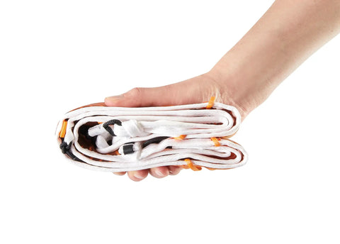 Hand holding folded Ultralight Mountaineering Harness With Openable Design For Ski Touring And Climbing Ultra Lightweight 100g Size Small