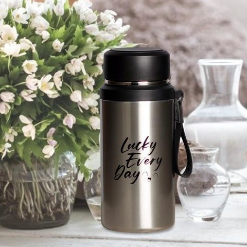 Insulated Water Bottle For On The Go Hydration 800ml Stainless Steel Flask next to flowers and glassware