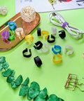 Assorted colorful 8mm bird leg bands set 200 pieces with 10 vivid colors clip on identification tags on a table.