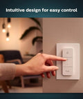 Smart Wireless Dimmer Switch V2 for Hue Lights, no bridge needed, in use on a living room wall, intuitive for indoor lighting control.