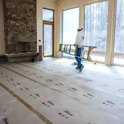 X Board Paint and Remodel Surface Protector Heavy Duty Breathable Floor Shield 35 Inch by 100 Feet Roll in room with fireplace