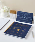 Open House Guest Sign In Book And Realtor Tent Cards Set 2 Pack Navy Blue 8.5 By 11 Real Estate Agent Supplies For Open Houses Home Showings And Client Sign In displayed on a table with flowers.