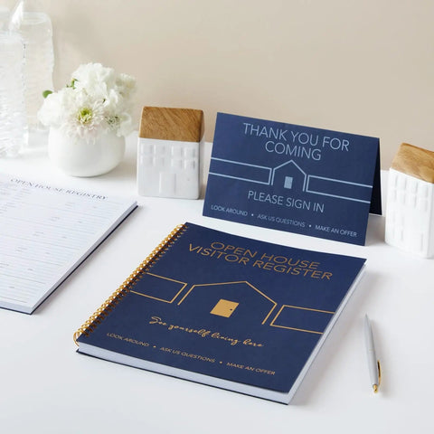 Open House Guest Sign In Book And Realtor Tent Cards Set 2 Pack Navy Blue 8.5 By 11 Real Estate Agent Supplies For Open Houses Home Showings And Client Sign In displayed on a table with flowers.