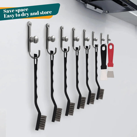 15 Piece Mini Stainless Steel Wire Brush Set With Curved Handles For Removing Rust And Welding Slag, Includes 2 Cleaning Scrapers, hanging on wall hooks in a garage or workshop setting.