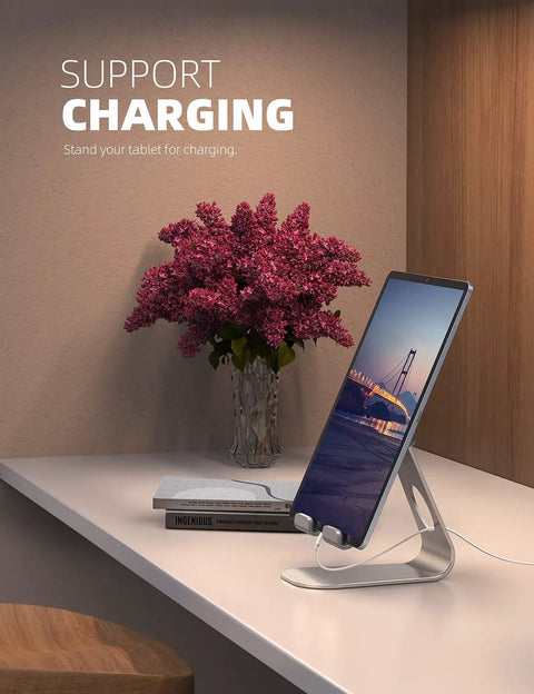 Adjustable Tablet Stand For 4 To 13 Inch Tablets And Phones Desktop Holder For iPad Pro Models Air Mini Kindle Switch Galaxy Tab And More Ideal Office Desk Accessory For Home And Work showcasing a charging tablet on a desk.