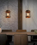 Rustic Farmhouse Pendant Lights Two Pack In Solid Oak And Matte Black Metal Cages With Long Adjustable Chains in a cozy dining setting.