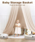 Child standing in front of two storage baskets with toys, under a beige canopy; image for Large Dog Toy Storage Basket Rope Bin 30L For Toys And Blankets Pet Gear White And Brown 19.7 X 11 X 7.9 Inches Durable Woven Rope Organizer For Living Room Or Bedroom.