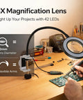 3X LED Magnifying Table Clamp Helping Hand With Flexible Arm Soldering Station in use on a circuit board with flexible arms and 60mm lens