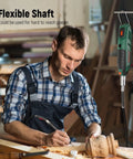Man using Pro Grade Rotary Tool Kit 180W Power With 6 Speeds Up To 40000 RPM And Variable Speed Universal Keyless Chuck And Flex Shaft 128 Accessories for carving.