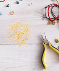 Top Shelf Stainless Steel Bail Beads For Jewelry Making Supplies Featuring Durable Charm Hangers and Smooth Spacer Beads scattered with jewelry tools.
