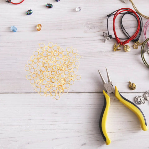 Top Shelf Stainless Steel Bail Beads For Jewelry Making Supplies Featuring Durable Charm Hangers and Smooth Spacer Beads scattered with jewelry tools.