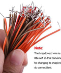 Hand holding 560 Piece Jumper Wire Kit With 14 Lengths Of Assorted Preformed Breadboard Wires, Male To Male 24 AWG U Shaped Jumpers