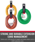 Heavy Duty Cord Straps Set With Grommets, Assorted Small Medium Large, Easy Hang Hook And Loop Organizer For Extension Cords, Garden Hose, And Tool Storage, 3 Pack For DIYers securing orange and green extension cords in a garage.