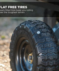 Close-up of a heavy duty dump cart's no flat 10 inch tire, part of the steel frame utility wagon for garden yard beach tough jobs.