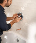 Person installing MPact PosiTemp Pressure Balancing Tub And Shower Valve With IPS Half Inch Connections Four Port Brass Valve Kit