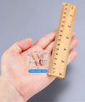 No Fuss Flat Head Machine Screws M1.4X14MM 304 Stainless Steel Phillips Drive beside ruler for size reference.
