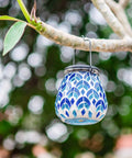 Solar Mosaic Lanterns For Outdoor Lighting hanging on a tree branch, blue and white glass, ideal for garden decor