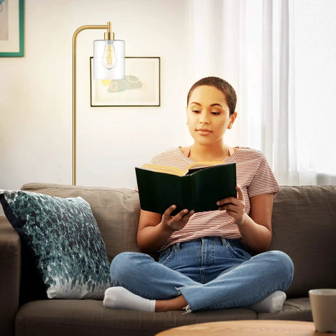 Indoor setting with woman reading by Industrial Floor Lamp With Dope Hanging Glass Shade And Brass Gold Farmhouse Indoor Pole Light Edison E26 Base Vintage Rustic Standing Tall For Living Room Bedroom Or Office Bulb Included