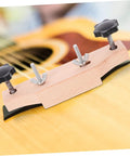 Guitar Bridge Clamp Repair Tool Set on acoustic guitar for precise bridge alignment, wood and metal construct