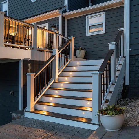 Stair Light Kit Four Pack Charcoal Black With Rugged Built To Take A Beating Powder Coated Aluminum Housing And Polycarbonate Lens Featuring Cree SMD LEDs 3000K illuminating exterior staircase.