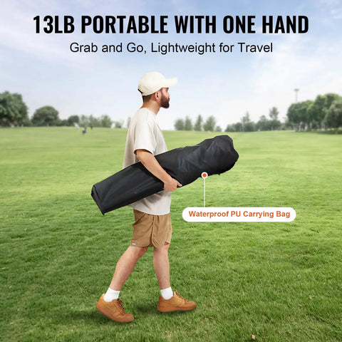 Man carrying 13lb portable Oversized Camping Folding Chair With Quad Lumbar Back Support in waterproof PU bag across grassy field.