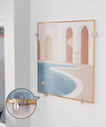 Foolproof Mirror Holder Kit Boasting 22 Slick Clear Plastic Clips With Heavy Duty Screws crafted for 3 16 inches of glass panels, displaying mounted art on wall.