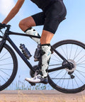 Top Tier Gear Chip Industrial Socks With 15-20mmHg Graduated Compression For Calf Support worn by cyclist on bike.