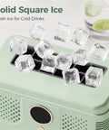 Sleek Countertop Ice Maker With Zero Sweat One Touch Operation And Smooth Self Cleaning Design Blazing Fast Cube Production For Weekend Hangouts Home Bars Or Office Chill Areas Ultra Compact showing fresh square ice cubes.