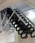 Electric Attic Ladder With Retractable Loft Stairs And Hidden Ceiling Access Featuring Heavy Duty Alloy Frame And Wide Non Slip Treads For One Push Motorized Operation To Keep Your Attic Storage On Point showing retractable stairs with black non-slip treads.
