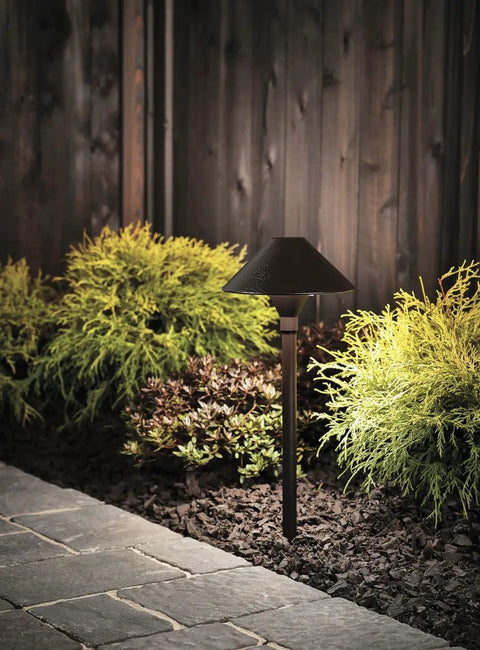 3 Watt Olde Bronze Low Voltage LED Path Light Single Fixture For Outdoor Garden Path Lighting Crafted From Aluminum With A Six Foot Beam Spread And Easy Accent Lighting On Walkways illuminating a garden path.