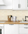 Thick Peel And Stick Backsplash Tiles In Beige Marble Look for Kitchen, shown installed in a bright kitchen setting.